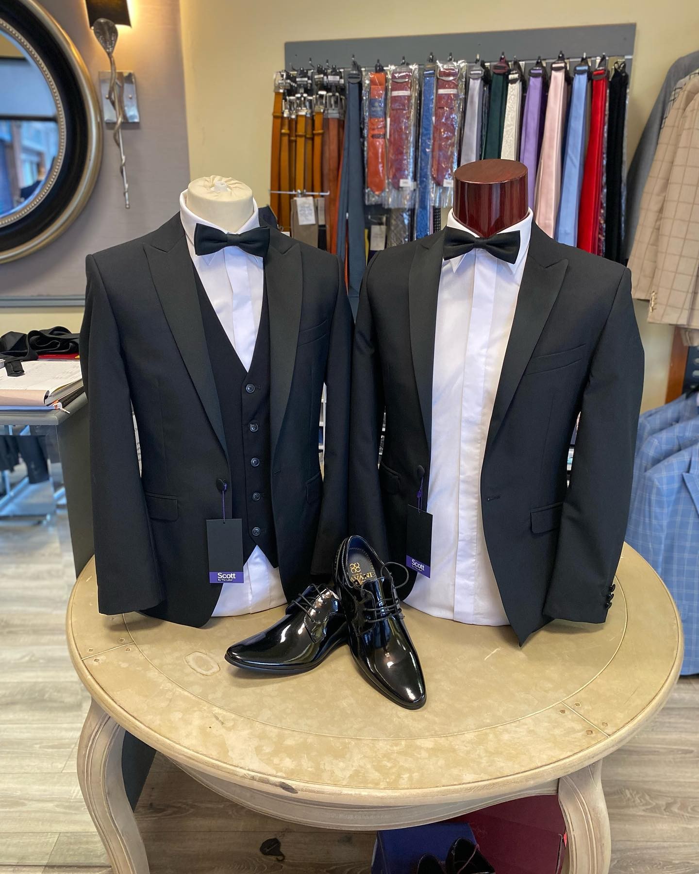 Black tie suits and formal shoes on display in the All Suits store