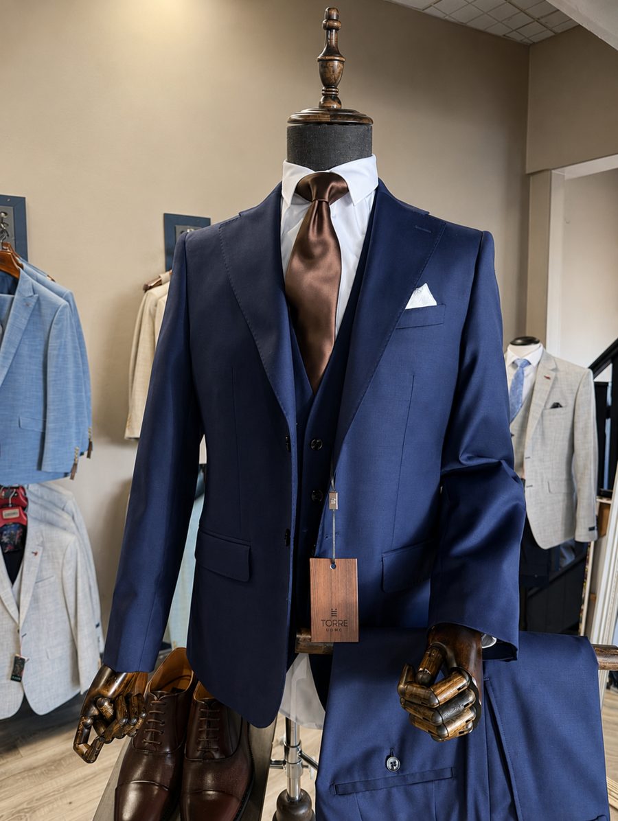 Navy suit with brown tie and pocket square styled in the All Suits store