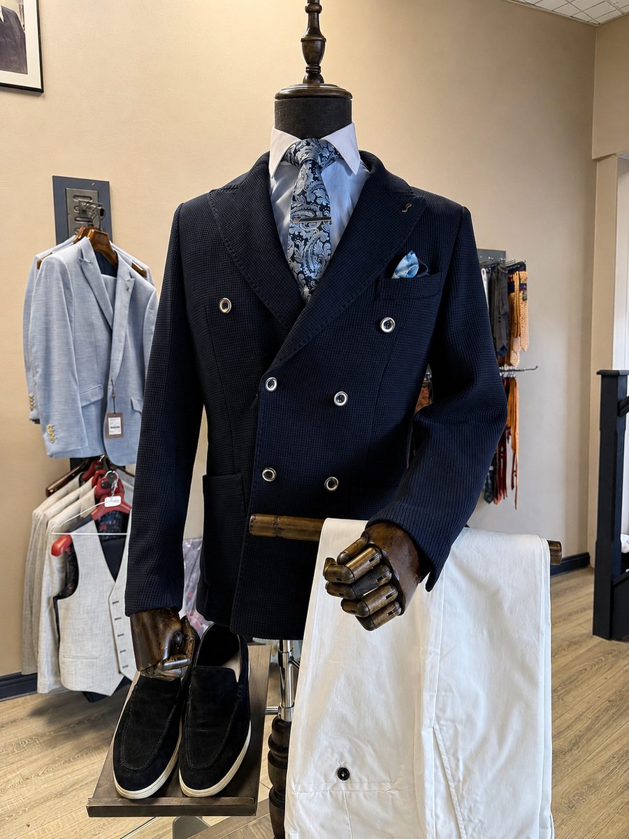 Navy double-breasted jacket with white trousers styled in the All Suits store