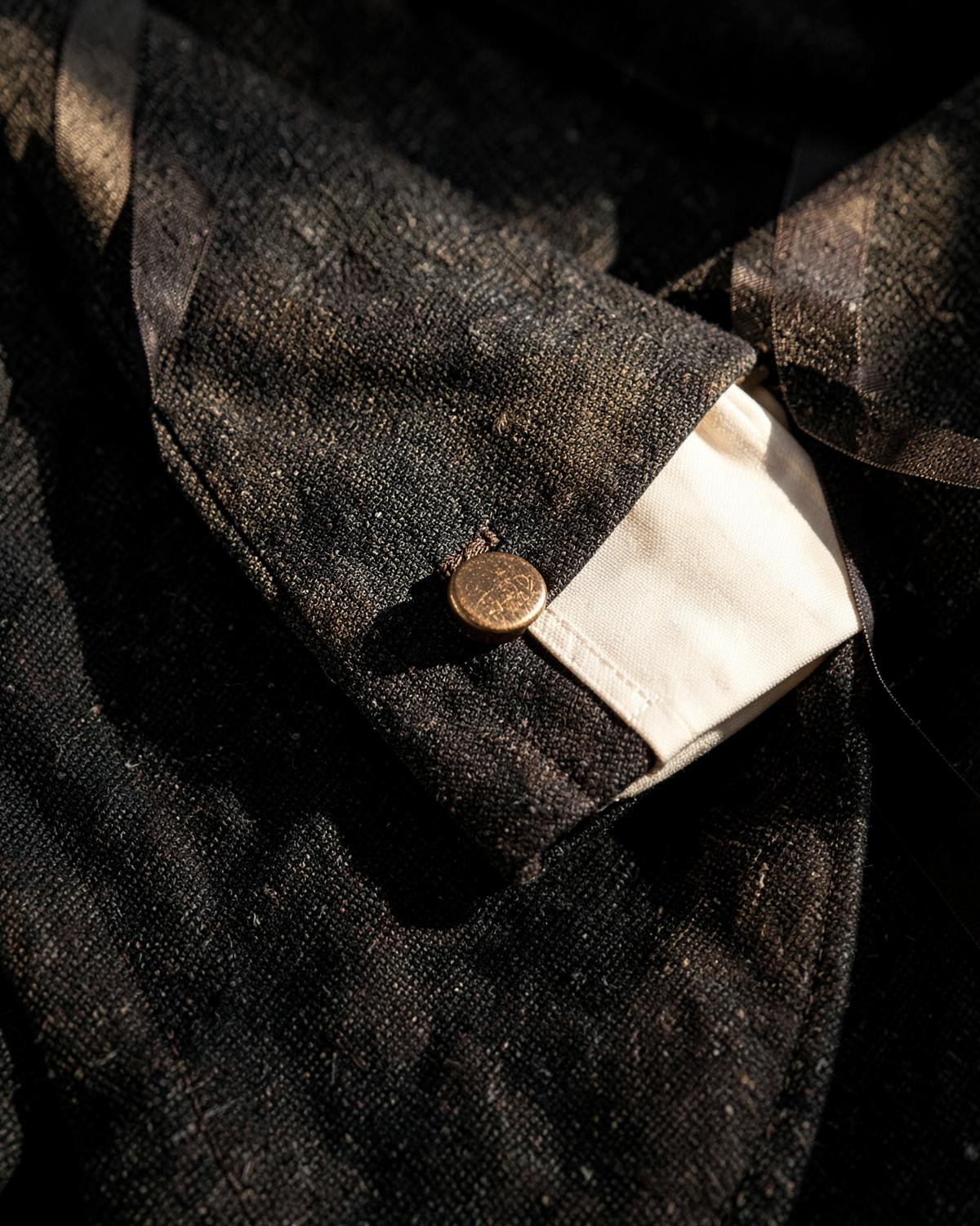 Close view of a charcoal suit cuff and tailoring details